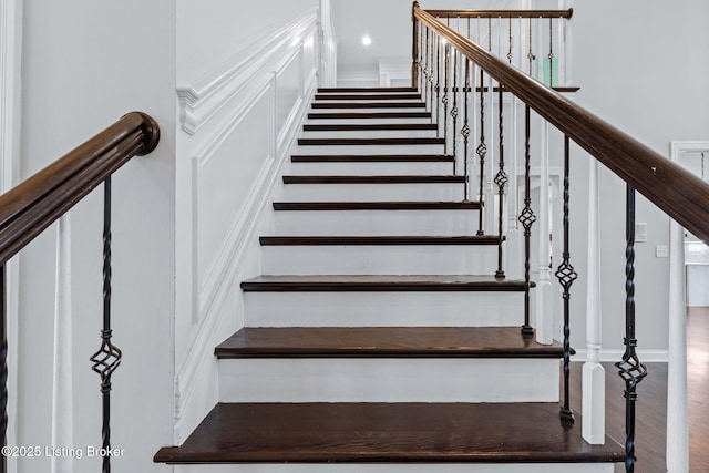 stairway featuring wood finished floors