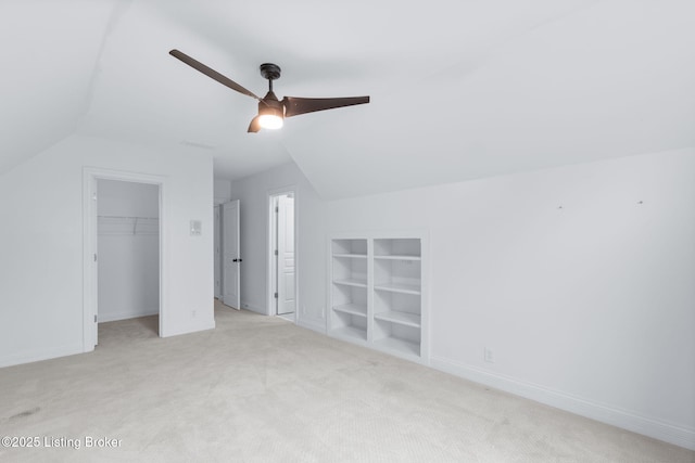 bonus room with vaulted ceiling, baseboards, a ceiling fan, and carpet flooring