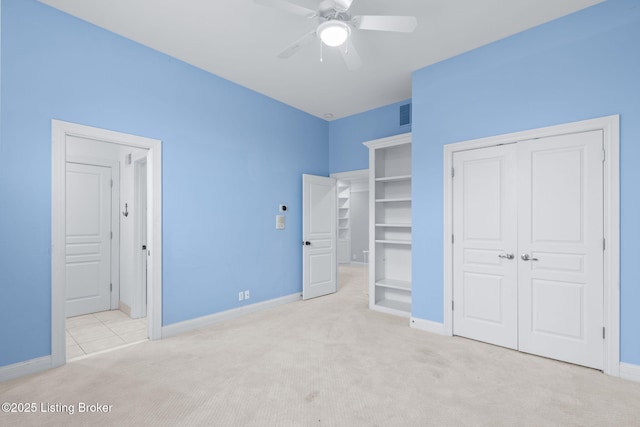 unfurnished bedroom featuring baseboards, carpet, ceiling fan, and visible vents