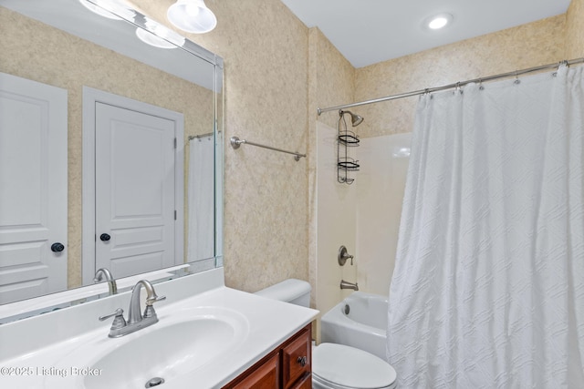bathroom featuring vanity, shower / bath combo, and toilet