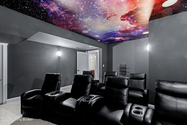 cinema room with baseboards and carpet flooring