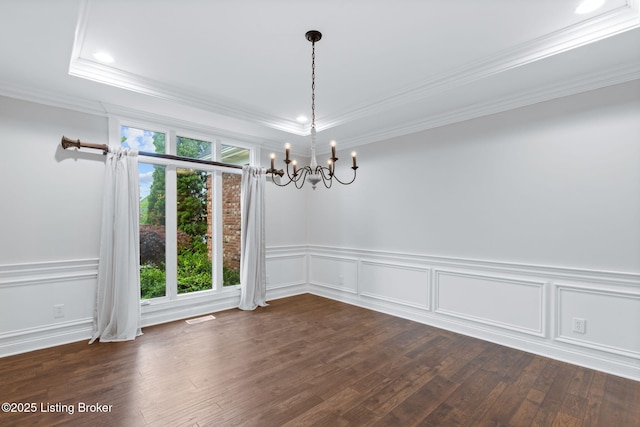 unfurnished dining area with crown molding, visible vents, a decorative wall, a chandelier, and dark wood finished floors