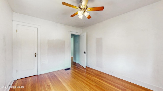 unfurnished bedroom featuring baseboards, ceiling fan, light wood-style flooring, and visible vents