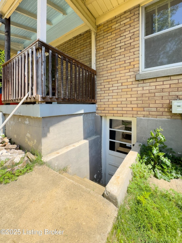 view of exterior entry featuring brick siding
