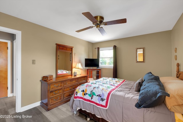 bedroom featuring light wood-type flooring and ceiling fan