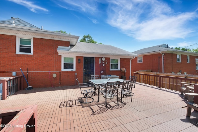 view of patio / terrace with a wooden deck and outdoor dining area