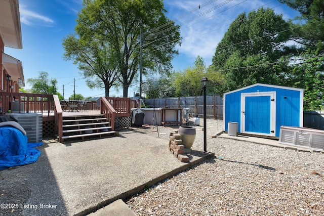 view of patio with an outdoor structure, a deck, a storage shed, central air condition unit, and a fenced backyard