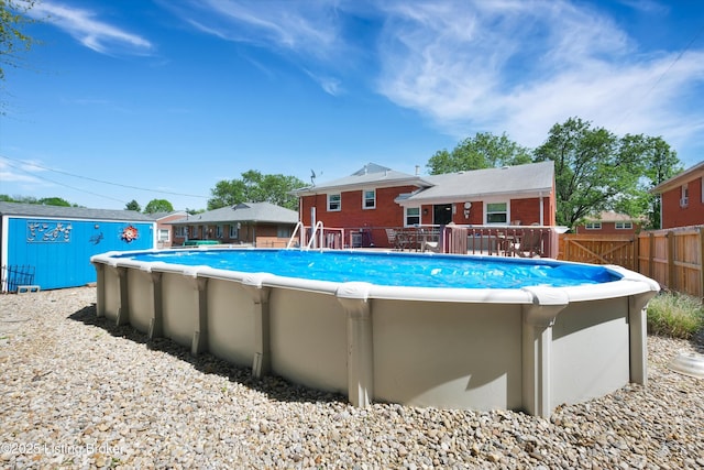 view of pool with fence, a wooden deck, and a fenced in pool