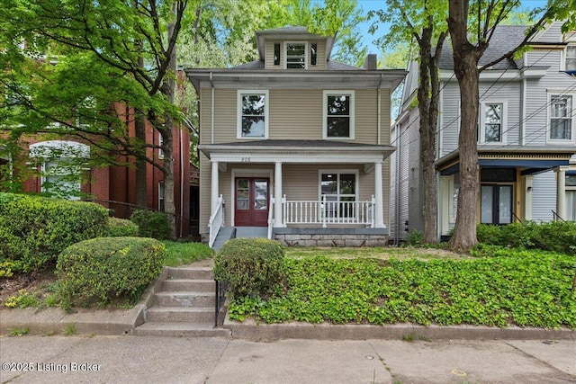 american foursquare style home with a porch and french doors