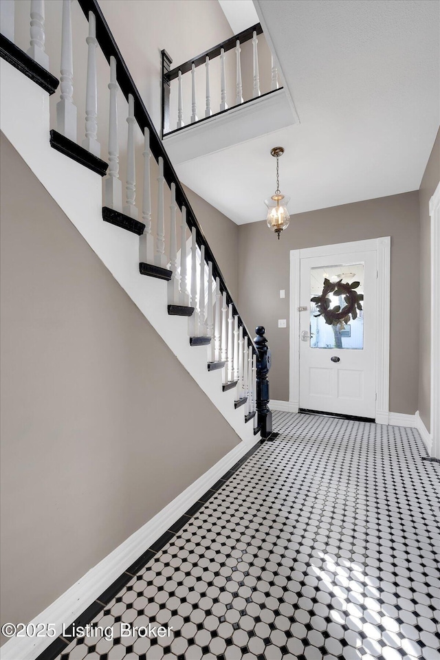206 E Madison St, La Grange, KY 40031 - foyer featuring baseboards, stairway, a chandelier, and carpet flooring