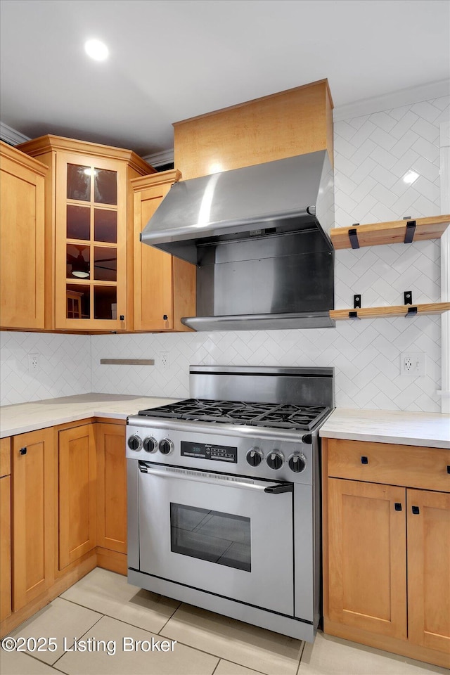 206 E Madison St, La Grange, KY 40031 - kitchen featuring gas stove, backsplash, light countertops, and wall chimney exhaust hood