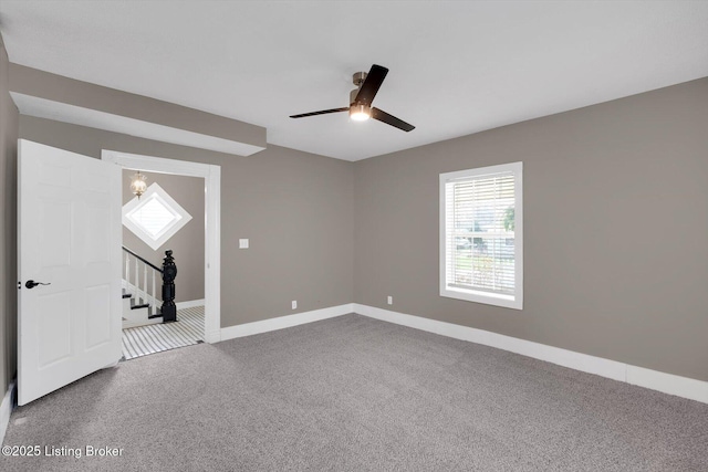 206 E Madison St, La Grange, KY 40031 - spare room featuring carpet, baseboards, ceiling fan, and stairs