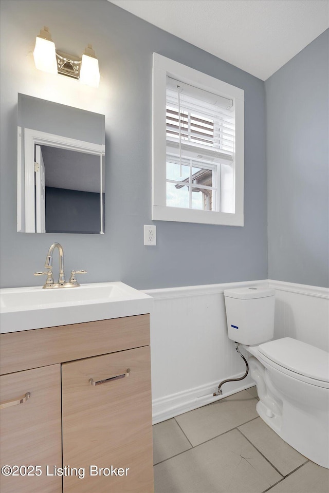 206 E Madison St, La Grange, KY 40031 - bathroom featuring toilet, vanity, tile patterned flooring, and wainscoting