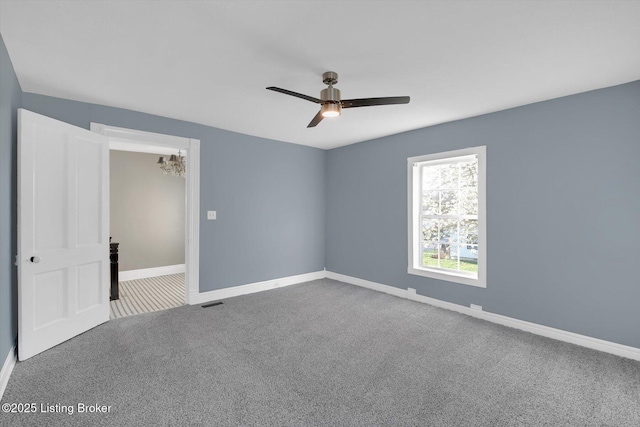 206 E Madison St, La Grange, KY 40031 - spare room featuring carpet flooring, ceiling fan, baseboards, and a chandelier