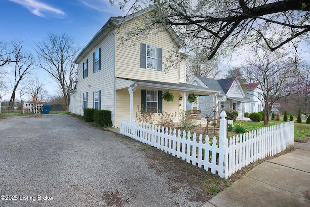 206 E Madison St, La Grange, KY 40031 - traditional-style home with covered porch, gravel driveway, and a fenced front yard