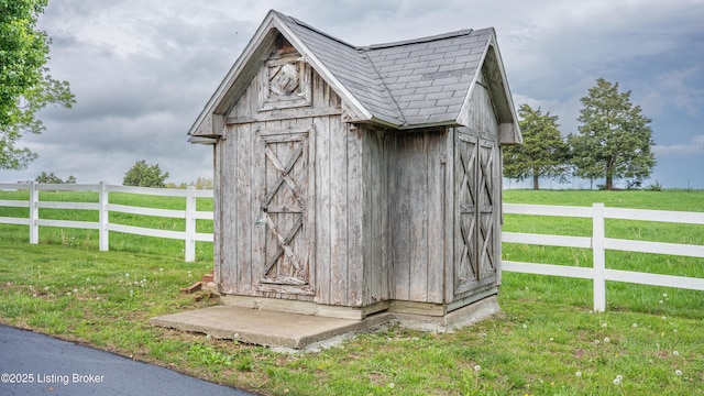 view of shed with fence