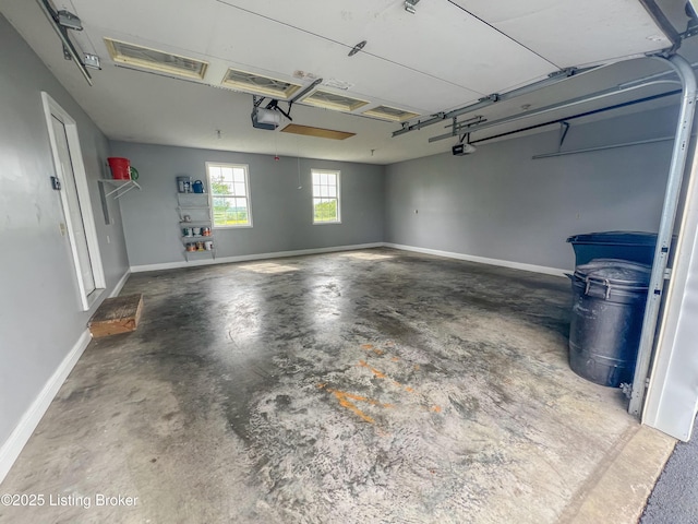 garage with a garage door opener and baseboards