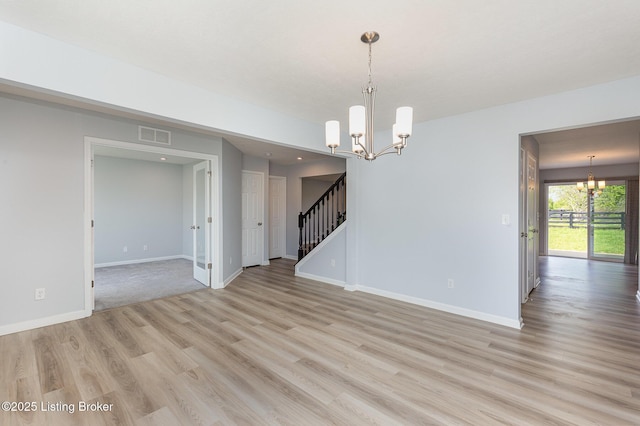 112 Shadow Rock Ct, Shepherdsville, KY 40165 - empty room with visible vents, stairway, a chandelier, baseboards, and light wood-type flooring