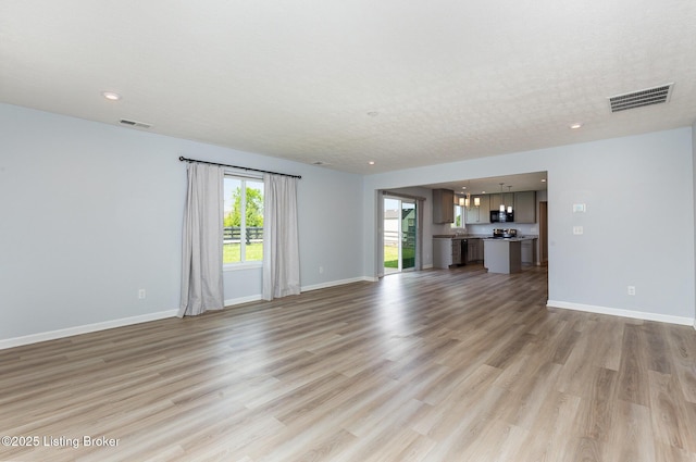 112 Shadow Rock Ct, Shepherdsville, KY 40165 - unfurnished living room with recessed lighting, visible vents, light wood-style flooring, and baseboards