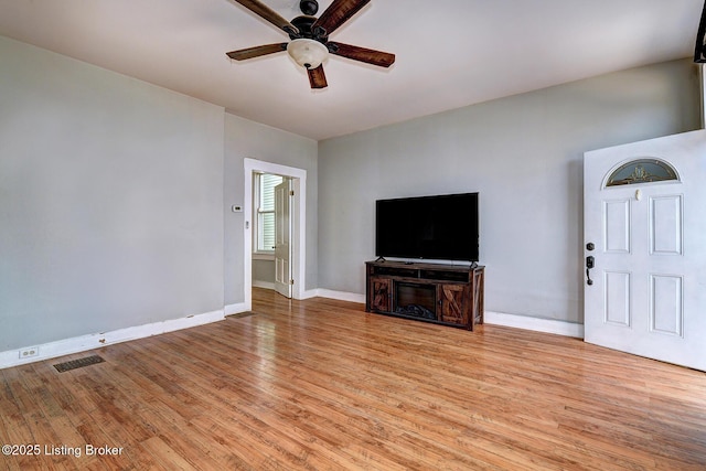 unfurnished living room featuring visible vents, a ceiling fan, light wood-style flooring, and baseboards