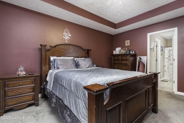 216 Willow Creek Dr, Mt Washington, KY 40047 - bedroom featuring a raised ceiling, ensuite bath, baseboards, a textured ceiling, and light colored carpet
