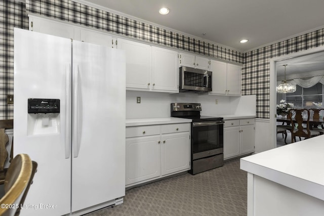 kitchen featuring an inviting chandelier, dark colored carpet, wallpapered walls, light countertops, and stainless steel appliances