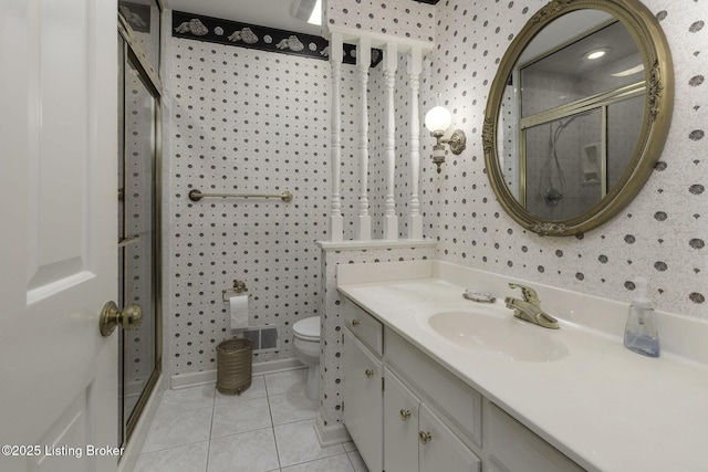 bathroom featuring toilet, wallpapered walls, tile patterned floors, and a stall shower