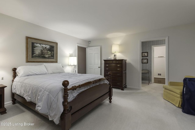 bedroom featuring light colored carpet and baseboards