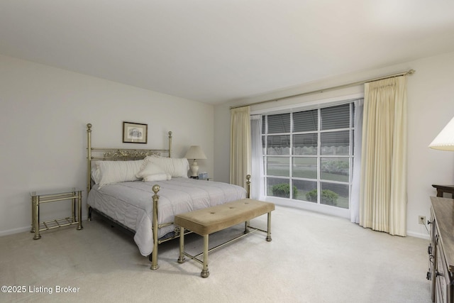 bedroom featuring baseboards and light carpet