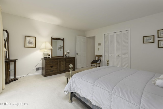 bedroom with baseboards, light colored carpet, and a closet
