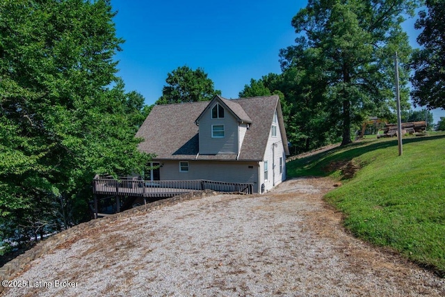 exterior space with a lawn and a wooden deck