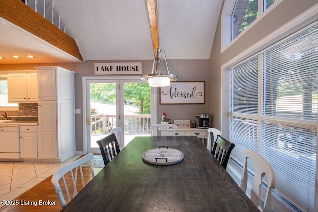 dining area featuring high vaulted ceiling and light tile patterned flooring