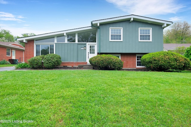 2311 Langdon Dr, Louisville, KY 40242 - tri-level home with a front lawn, board and batten siding, and brick siding