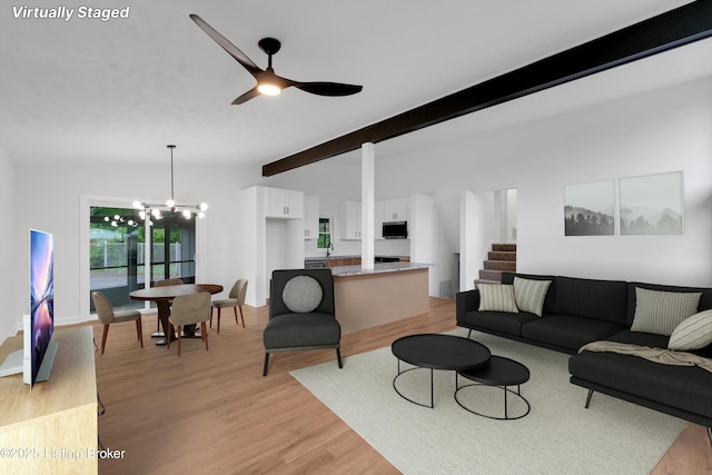 2311 Langdon Dr, Louisville, KY 40242 - living room with light wood-style floors, lofted ceiling with beams, baseboards, and ceiling fan with notable chandelier