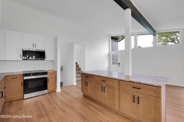 2311 Langdon Dr, Louisville, KY 40242 - kitchen with stainless steel microwave, light stone countertops, light wood-style floors, electric range oven, and tasteful backsplash