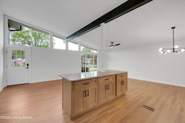 2311 Langdon Dr, Louisville, KY 40242 - kitchen with visible vents, a healthy amount of sunlight, light wood-style flooring, and beamed ceiling