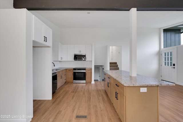 2311 Langdon Dr, Louisville, KY 40242 - kitchen with stainless steel microwave, electric stove, a sink, light wood-style floors, and dishwasher