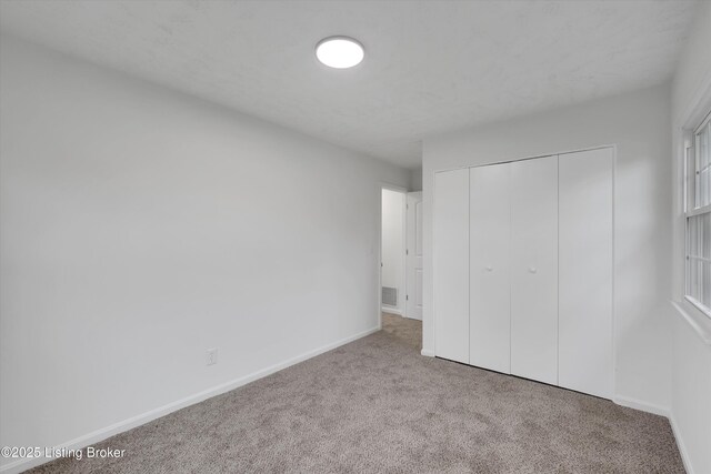 2311 Langdon Dr, Louisville, KY 40242 - unfurnished bedroom featuring visible vents, baseboards, carpet flooring, and a closet