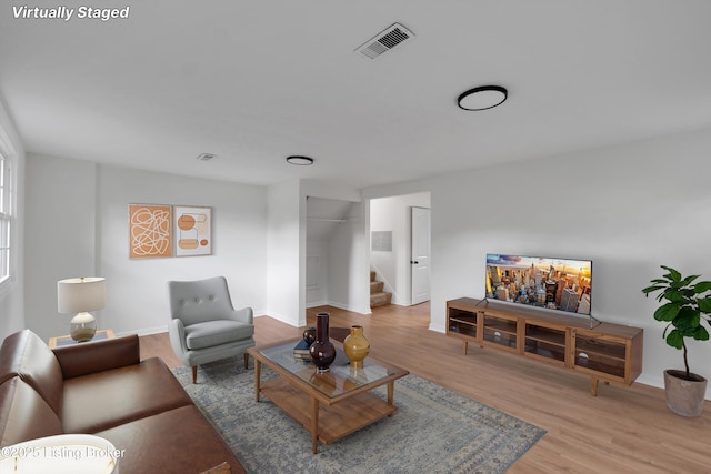 2311 Langdon Dr, Louisville, KY 40242 - living area with baseboards, visible vents, light wood finished floors, and stairway