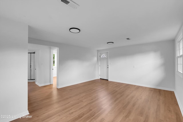 2311 Langdon Dr, Louisville, KY 40242 - unfurnished living room featuring visible vents, light wood-style flooring, and baseboards