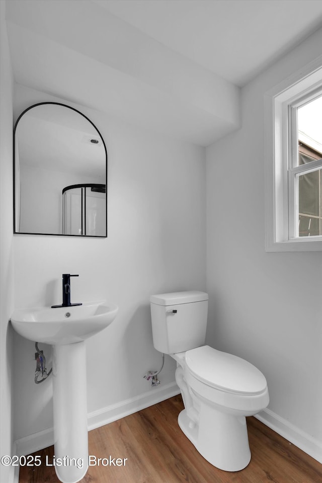 2311 Langdon Dr, Louisville, KY 40242 - bathroom with baseboards, wood finished floors, toilet, and a sink