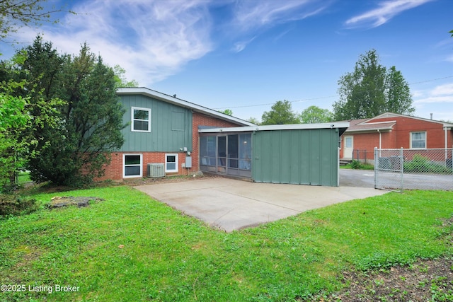 2311 Langdon Dr, Louisville, KY 40242 - rear view of property with a patio, a lawn, board and batten siding, brick siding, and fence