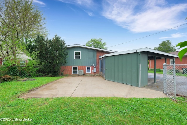 2311 Langdon Dr, Louisville, KY 40242 - back of property with fence, board and batten siding, a lawn, and brick siding