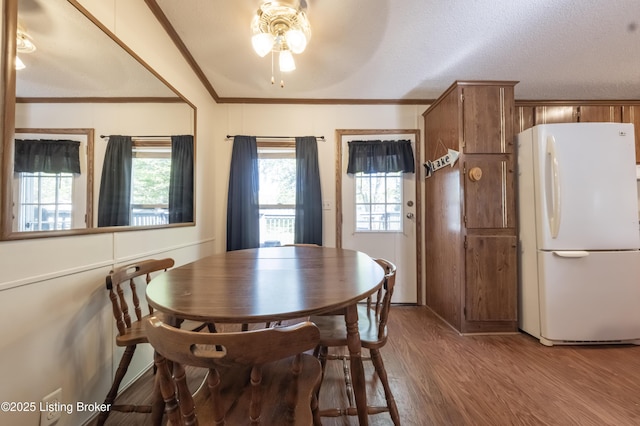 dining area featuring a ceiling fan, wood finished floors, and ornamental molding