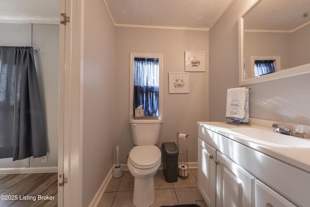 bathroom featuring crown molding, toilet, a textured ceiling, and vanity