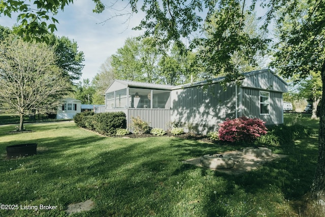 exterior space with a yard and a sunroom
