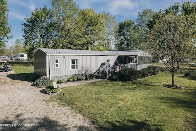 view of front of home with a front lawn and metal roof