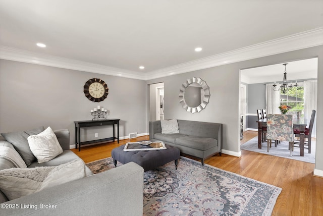 320 Biltmore Rd, Louisville, KY 40207 - living room featuring a chandelier, baseboards, light wood-style flooring, recessed lighting, and crown molding