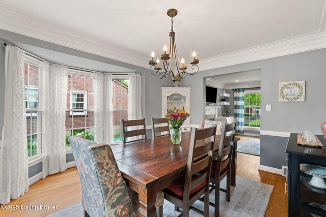 320 Biltmore Rd, Louisville, KY 40207 - dining room featuring a chandelier, light wood-style flooring, ornamental molding, and baseboards