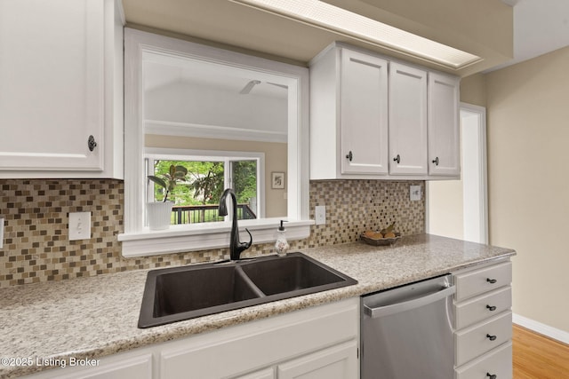 320 Biltmore Rd, Louisville, KY 40207 - kitchen featuring dishwasher, a sink, white cabinets, decorative backsplash, and light wood-style floors